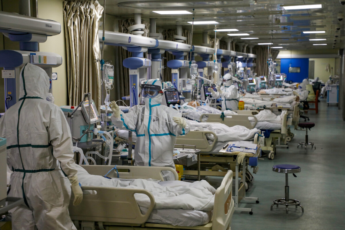 Medical workers in protective suits attend to COVID-19 patients at the intensive care unit (ICU) of a designated hospital during the coronavirus disease (COVID-19) outbreak in Wuhan, Hubei province, China, on Feb. 6, 2020. (China Daily via Reuters)