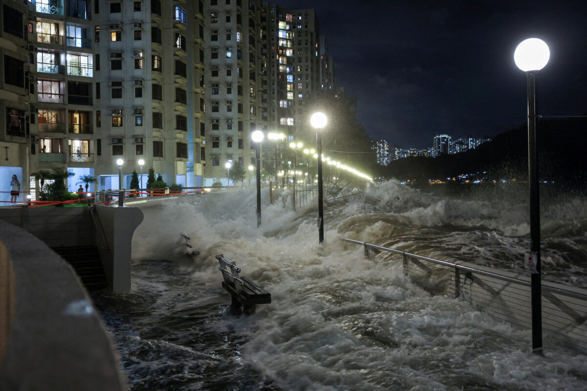 Waves from Super Typhoon Ragasa crash onto chairs by the shore in Hong Kong on Sept. 23, 2025. (Tyrone Siu/Reuters)