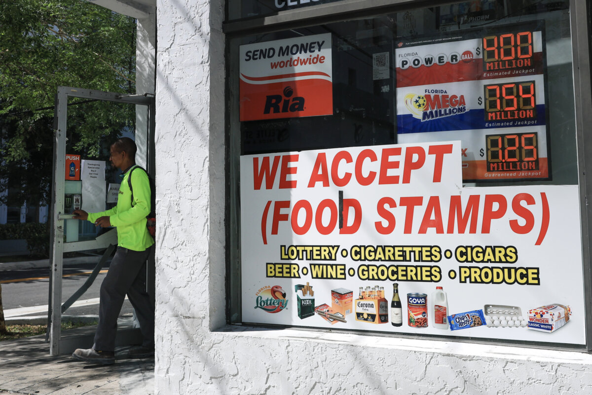 A 'We Accept (Food Stamps)' sign hangs in the window of a grocery store in Miami on Oct. 31, 2025. (Joe Raedle/Getty Images)