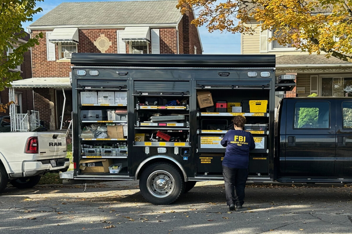 An FBI agent stands by an Evidence Response Team truck outside a home in a Dearborn, Mich., neighborhood on Oct. 31, 2025. (Mike Householder/AP Photo)