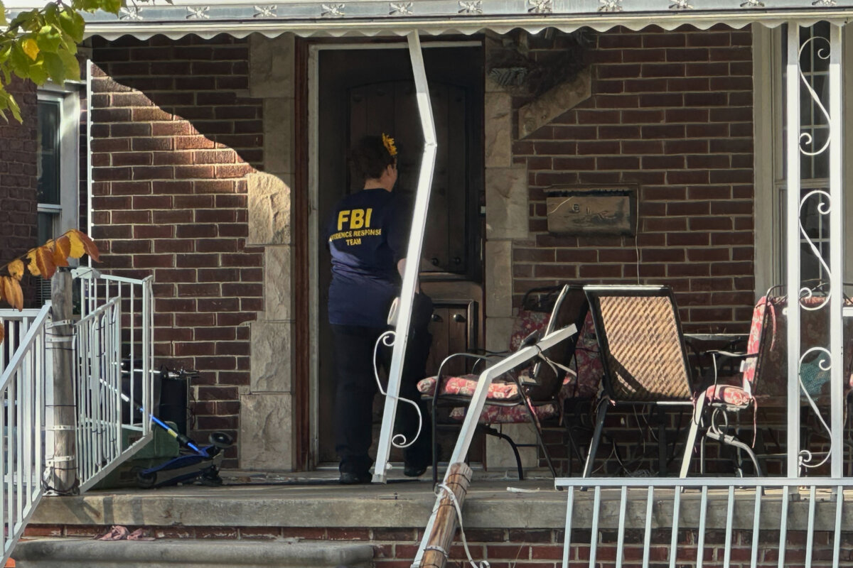 An FBI agent enters a home in a Dearborn, Mich., neighborhood on Oct. 31, 2025. (Mike Householder/AP Photo)