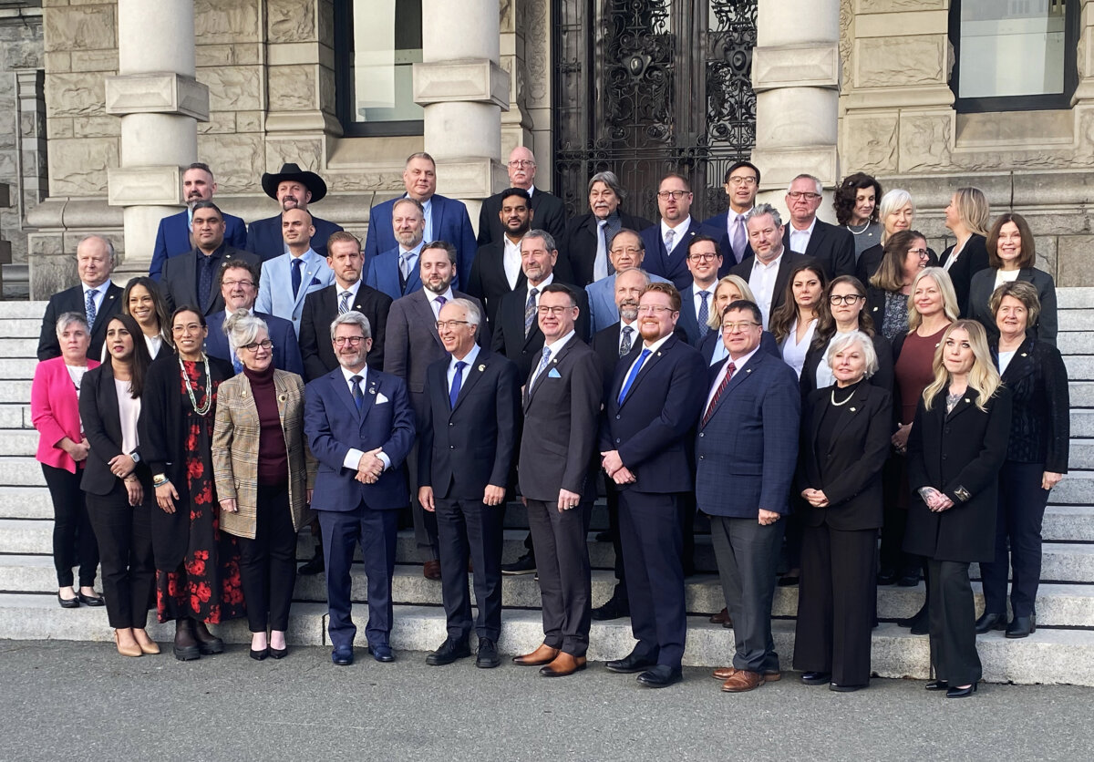 The B.C. Conservative Party caucus poses for an impromptu photo in front of the legislature in Victoria following a caucus meeting on Dec. 10, 2024. (The Canadian Press/Dirk Meissner)