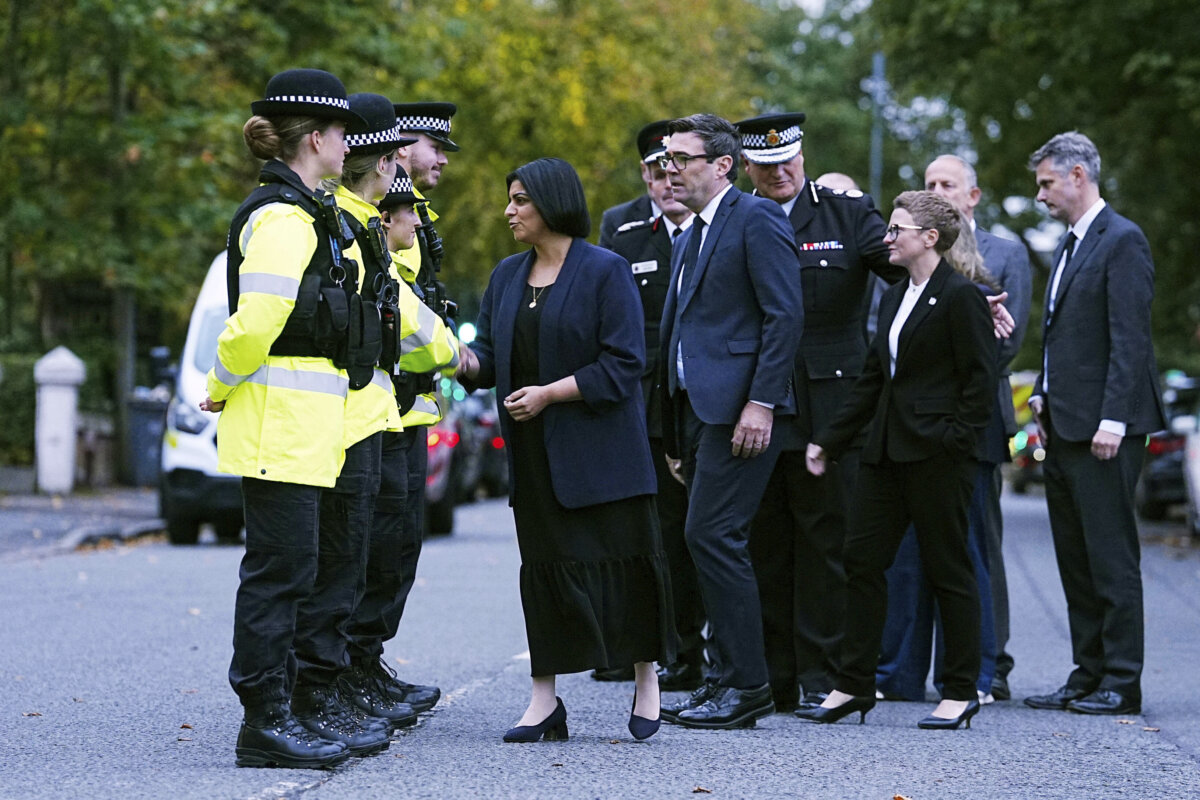 British Home Secretary Shabana Mahmood (C) shakes hands with police officers as she visits the scene of a terrorist attack at Heaton Park Hebrew Congregation synagogue in Crumpsall, Manchester, on Oct. 2, 2025. (Peter Byrne/PA via AP)
