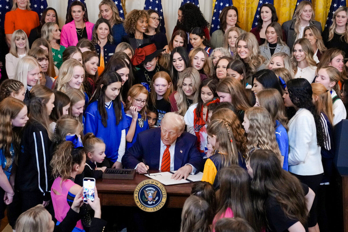President Trump, joined by female athletes, signs the “No Men in Women’s Sports” executive order in the East Room of the White House on Feb. 5, 2025. (Andrew Harnik/Getty Images)