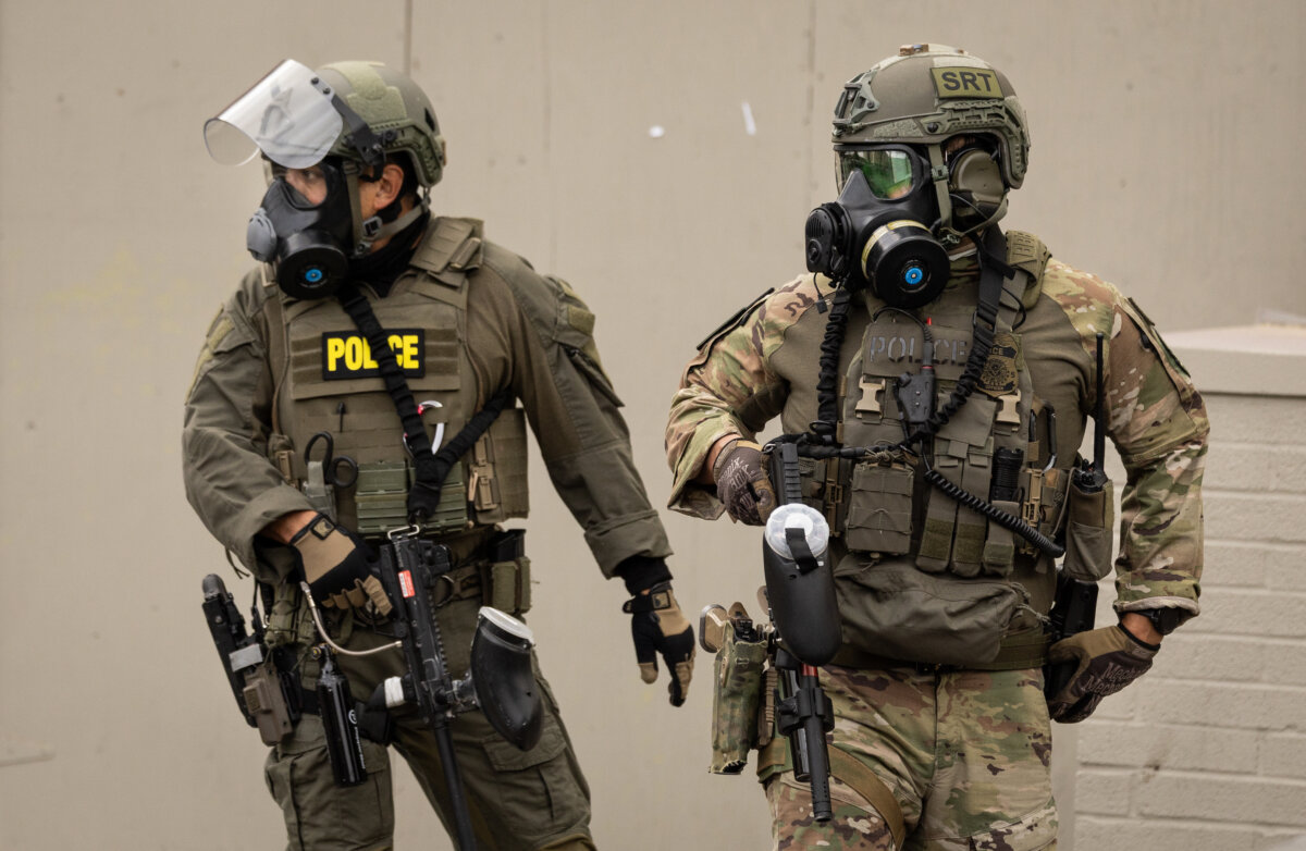 Federal agents move away protestors in front of Immigration and Customs Enforcement offices in Portland, Ore., on Oct. 4, 2025. (John Fredricks/The Epoch Times)