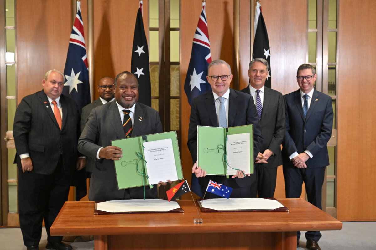 Australia’s Prime Minister Anthony Albanese and Papua New Guinea’s Prime Minister James Marape sign a defense treaty at Parliament House in Canberra, Australia, on Oct. 6, 2025. (AAP Image/Mick Tsikas)