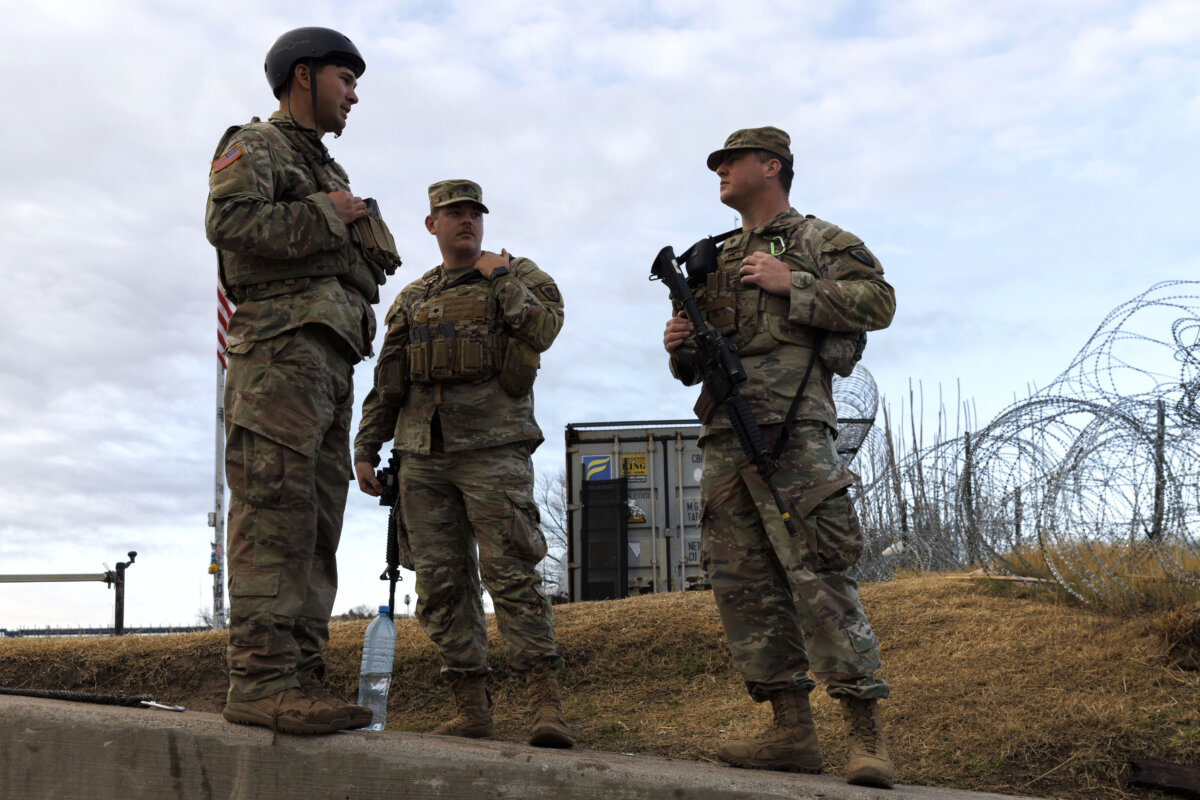 Texas National Guard soldiers wait nearby the boat ramp where law enforcement enter the Rio Grande at Shelby Park in Eagle Pass, Texas, on Jan. 26, 2024. (Michael Gonzalez/Getty Images)