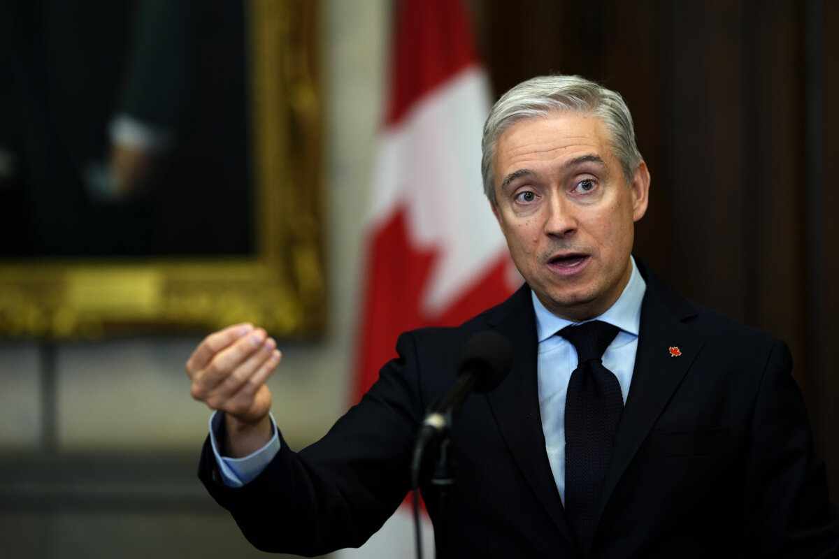 Minister of Finance and National Revenue François-Philippe Champagne speaks in the foyer of the House of Commons on Parliament Hill in Ottawa, on Oct. 6, 2025. (THE CANADIAN PRESS/Justin Tang)