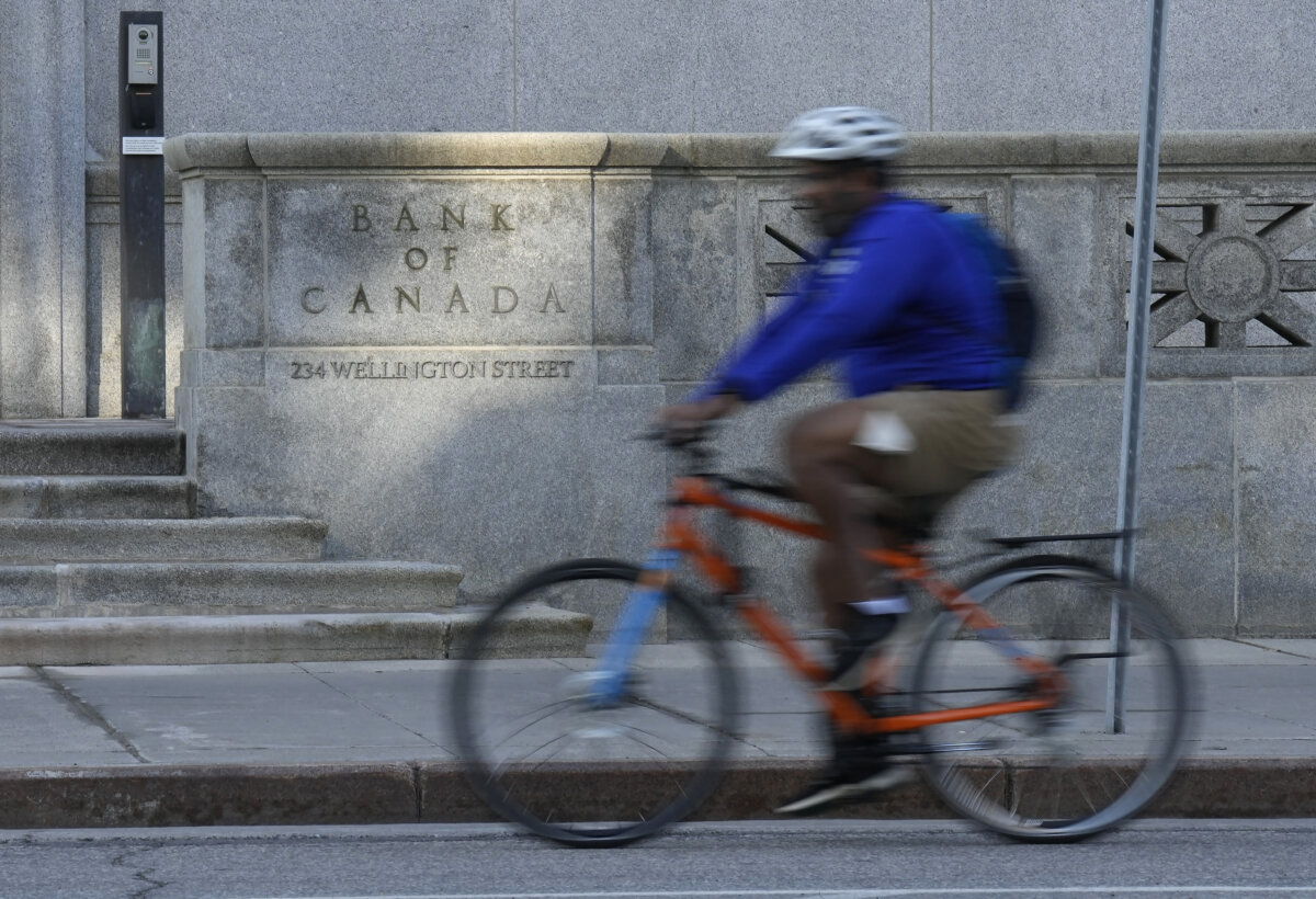 A cyclist rides past the Bank of Canada in Ottawa, on Sept. 17, 2025. (The Canadian Press/Adrian Wyld)