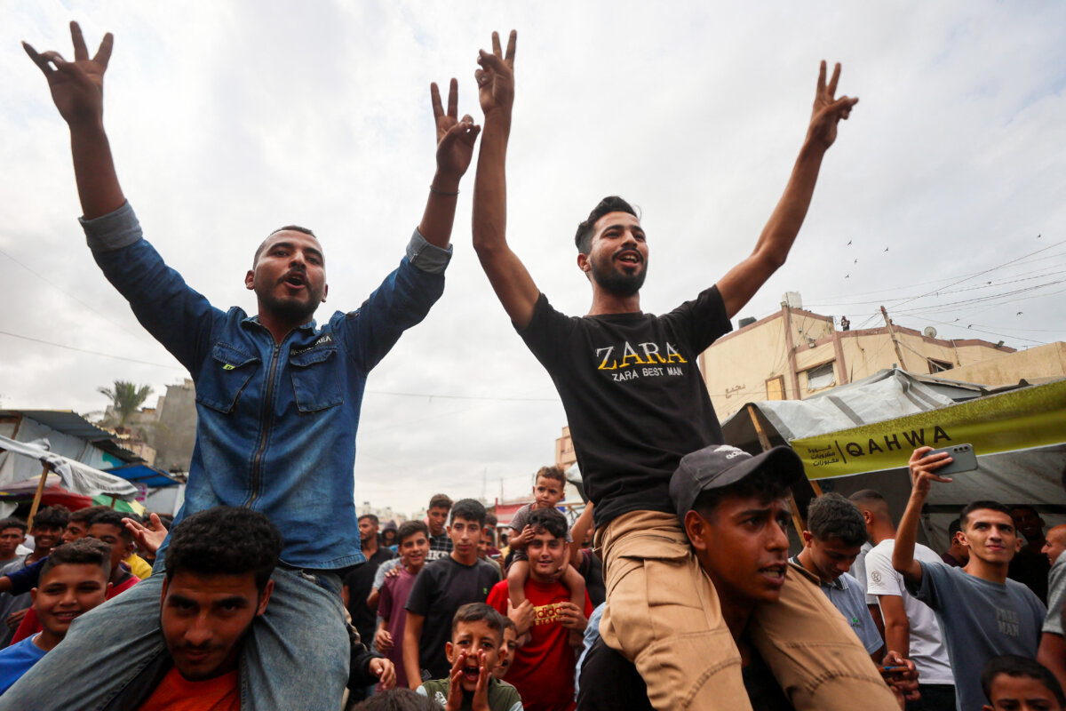 Palestinians celebrate in Khan Yunis on October 9, 2025, following news of a new Gaza ceasefire deal. Israel and Hamas on October 9 agreed a Gaza ceasefire deal to free the remaining living hostages, in a major step towards ending a war that has killed tens of thousands of people and unleashed a humanitarian catastrophe. (Photo by Omar AL-QATTAA / AFP) (Photo by OMAR AL-QATTAA/AFP via Getty Images)