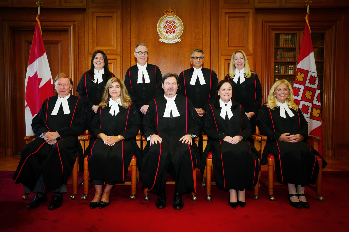 Supreme Court of Canada justices (L–R) Malcolm Rowe, Michelle O'Bonsawin, Andromache Karakatsanis, Nicholas Kasirer, Richard Wagner, Mahmud Jamal, Suzanne Côté, Mary T. Moreau, and Sheilah L. Martin wear their new robes as they take part in the official bench photo in the Judges’ Conference Room at the Supreme Court of Canada in Ottawa on Oct. 6, 2025. (The Canadian Press/Sean Kilpatrick)