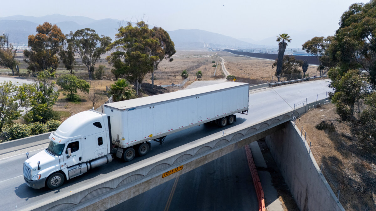 A semi-truck from Tijuana, Mexico, as it makes its way across a bridge into the United States after clearing customs at the Otay Mesa border in San Diego, Calif., on July 15, 2025. (Mike Blake/Reuters)