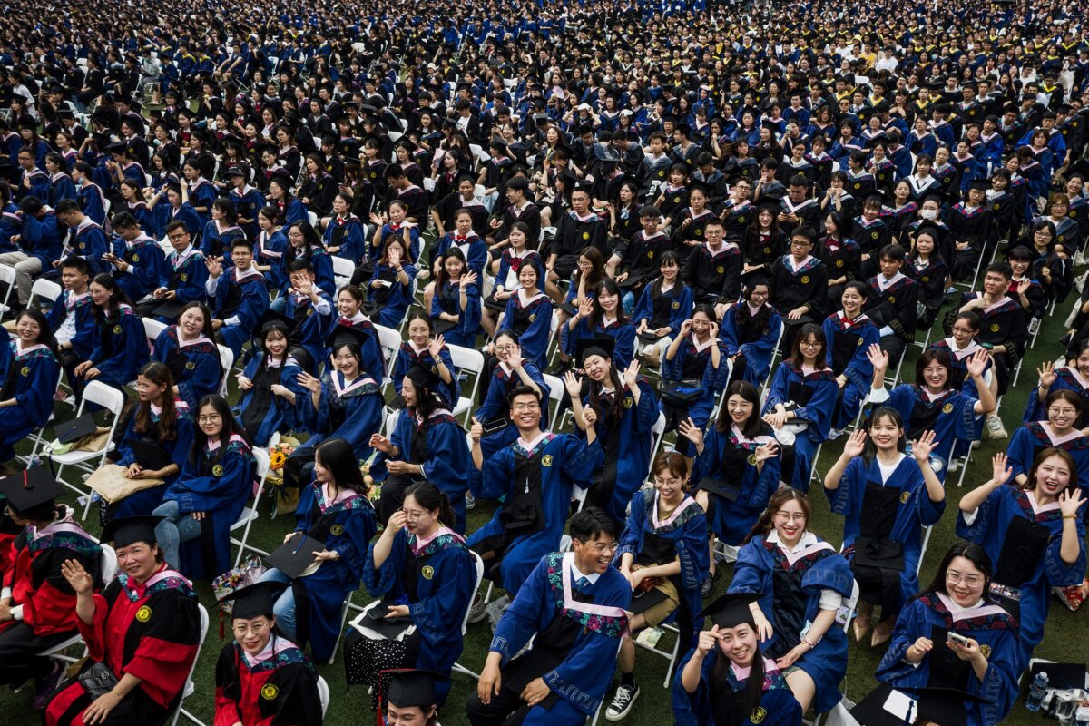 Nearly 11,000 graduates, including more than 2,000 students who could not attend the graduation ceremony the previous year due to COVID-19, attend a graduation ceremony at Central China Normal University in Wuhan, in China's central Hubei province, on June 13, 2021. (STR/AFP via Getty Images)