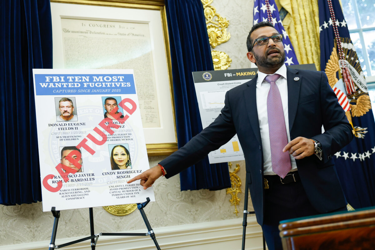 Federal Bureau of Investigation Director Kash Patel points to a display of captured most wanted fugitives during a news conference in the Oval Office on Oct. 15, 2025. (Kevin Dietsch/Getty Images)