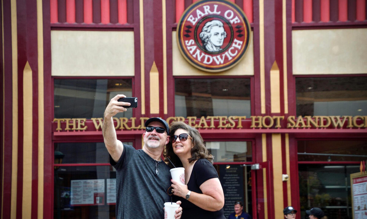 Steve Tolle and his wife, Emily Tolle, take a selfie in front of the re-opened Earl of Sandwich in the Downtown Disney District at the Disneyland Resort in Anaheim, CA, on Monday, Oct 1, 2018. (Jeff Gritchen/Orange County Register/TNS)