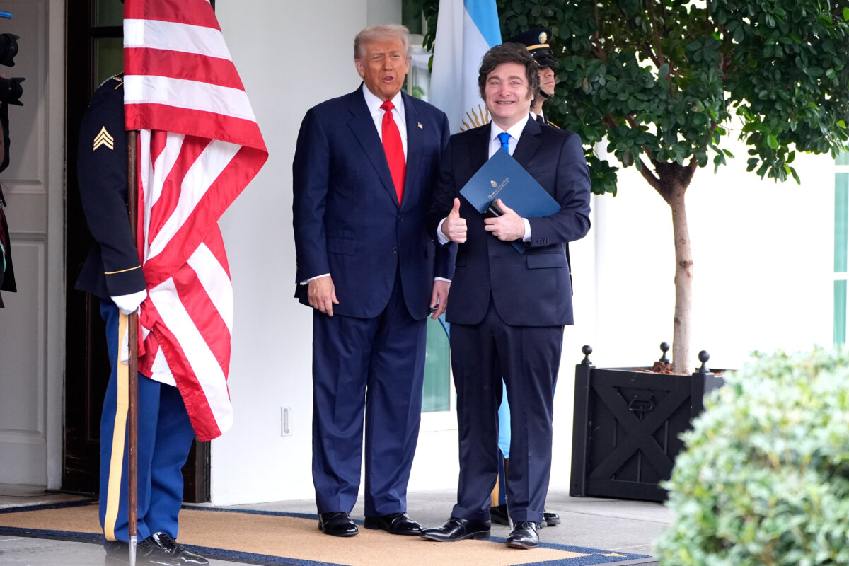 U.S. President Donald Trump greets Argentina's President Javier Milei as he arrives at the White House on Oct. 14, 2025. (AP Photo/Mark Schiefelbein)