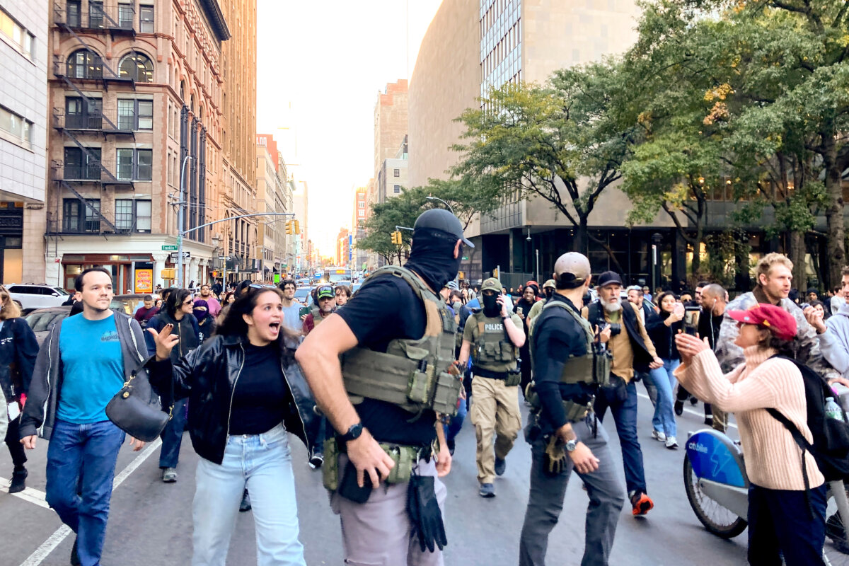 Protestors confront Federal agents as they walk down Lafayette Street after an immigration sweep on Canal Street through Chinatown, in New York on Oct. 21, 2025. (Jake Offenhartz/AP Photo)