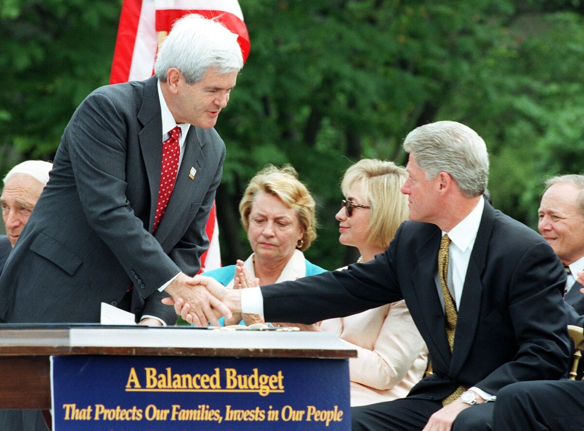 House Speaker Newt Gingrich (L) (R-Ga.) shakes hands with President Bill Clinton (R) before the President signed the Balanced Budget Agreement on the South Lawn of the White House in Washington on Aug. 5, 1997. (Paul J. Richards/AFP via Getty Images)