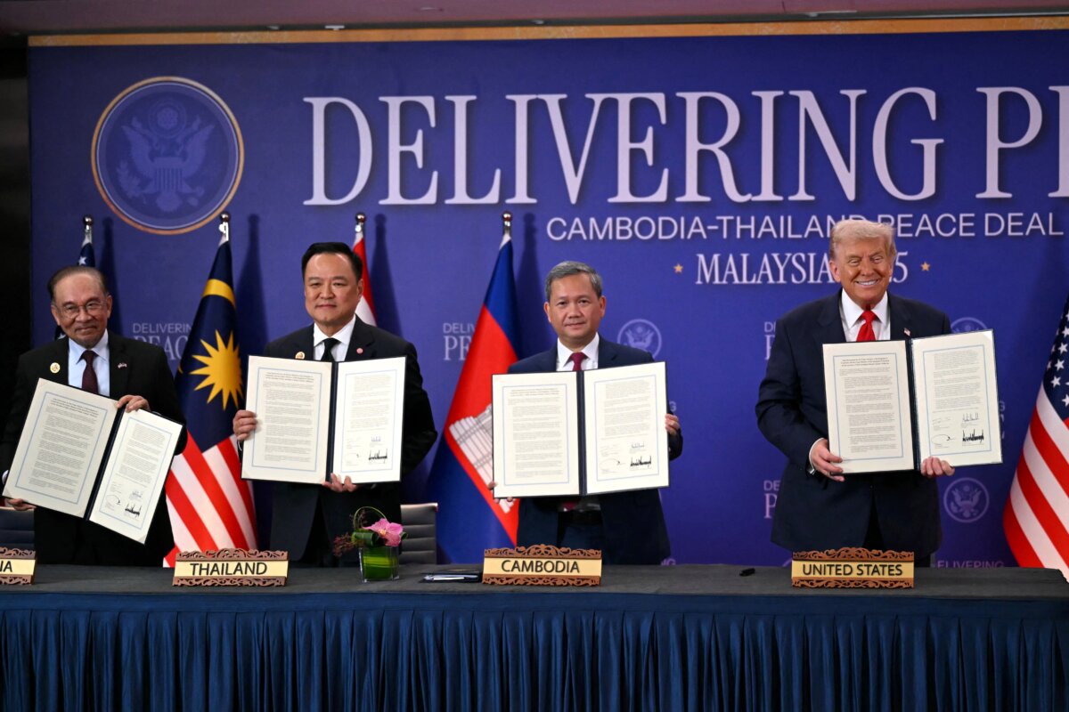 (L–R) Malaysian Prime Minister Anwar Ibrahim, Thai Prime Minister Anutin Charnvirakul, Cambodian Prime Minister Hun Manet, and U.S. President Donald Trump take part in the ceremonial signing of a cease-fire agreement on the sidelines of the 47th Association of Southeast Asian Nations Summit in Kuala Lumpur, Malaysia, on Oct. 26, 2025. (Andrew Caballero-Reynolds/AFP via Getty Images)