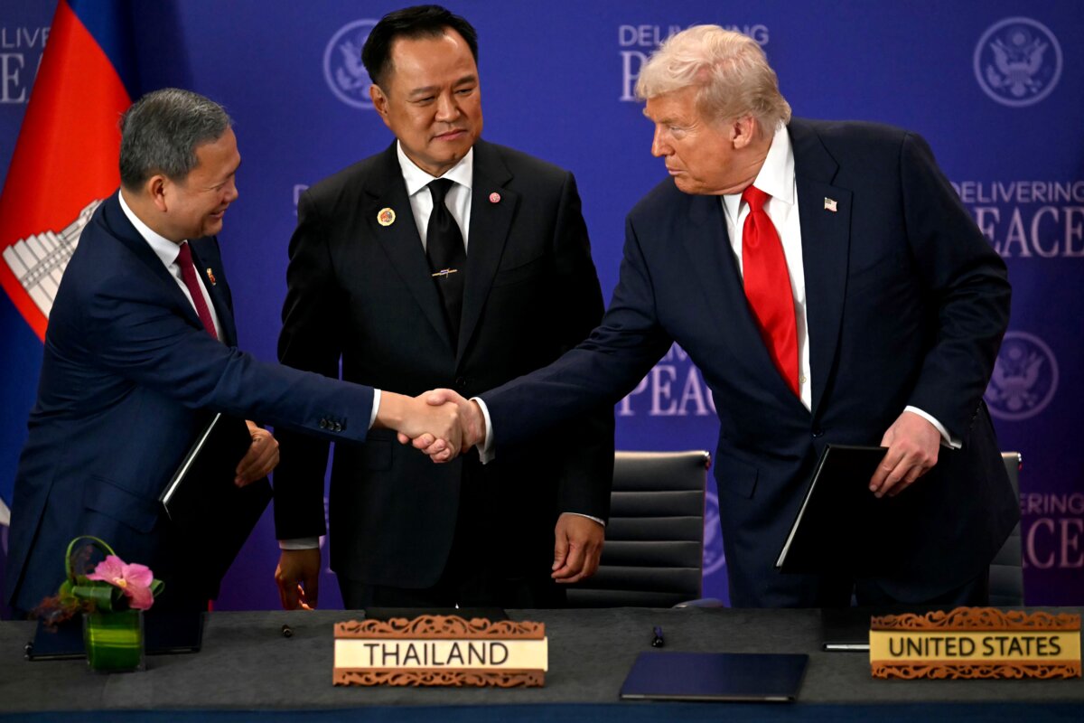 Thai Prime Minister Anutin Charnvirakul watches Cambodian Prime Minister Hun Manet (L) and U.S. President Donald Trump shake hands on the sidelines of the 47th Association of Southeast Asian Nations summit in Kuala Lumpur, Malaysia, on Oct. 26, 2025. (Mohd Rasfan/Pool Photo via AP)