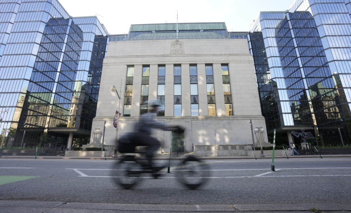 A cyclist rides past the Bank of Canada in Ottawa, on Sept. 17, 2025. (The Canadian Press/Adrian Wyld)