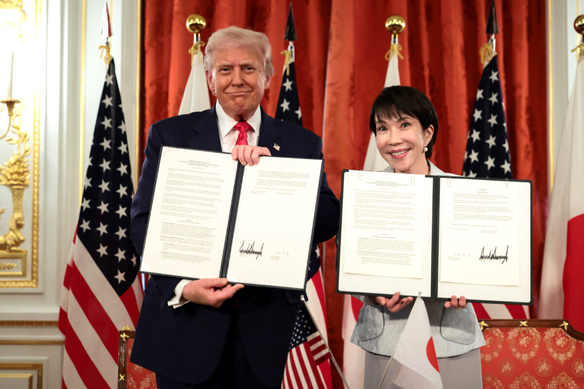 U.S. President Donald Trump (L) and Japanese Prime Minister Sanae Takaichi hold up signed documents regarding securing the supply of critical minerals and rare earths, at a bilateral meeting at Akasaka Palace in Tokyo on Oct. 28, 2025. (Evelyn Hockstein/Reuters)