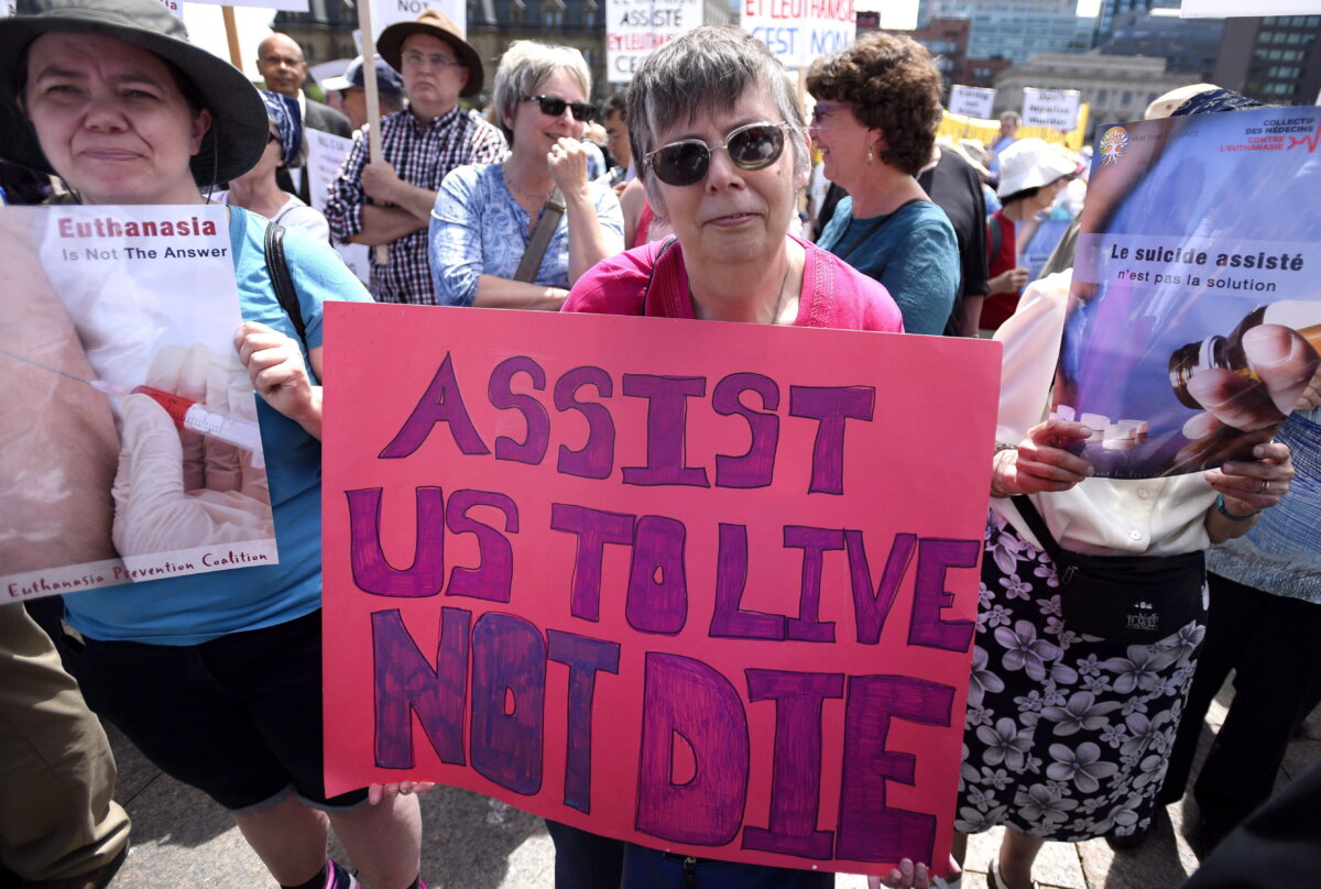 People rally against Bill C-14, the medically assisted dying bill, during a protest organized by the Euthanasia Prevention Coalition on Parliament Hill in Ottawa, Canada, on June 1, 2016. (Justin Tang /The Canadian Press)