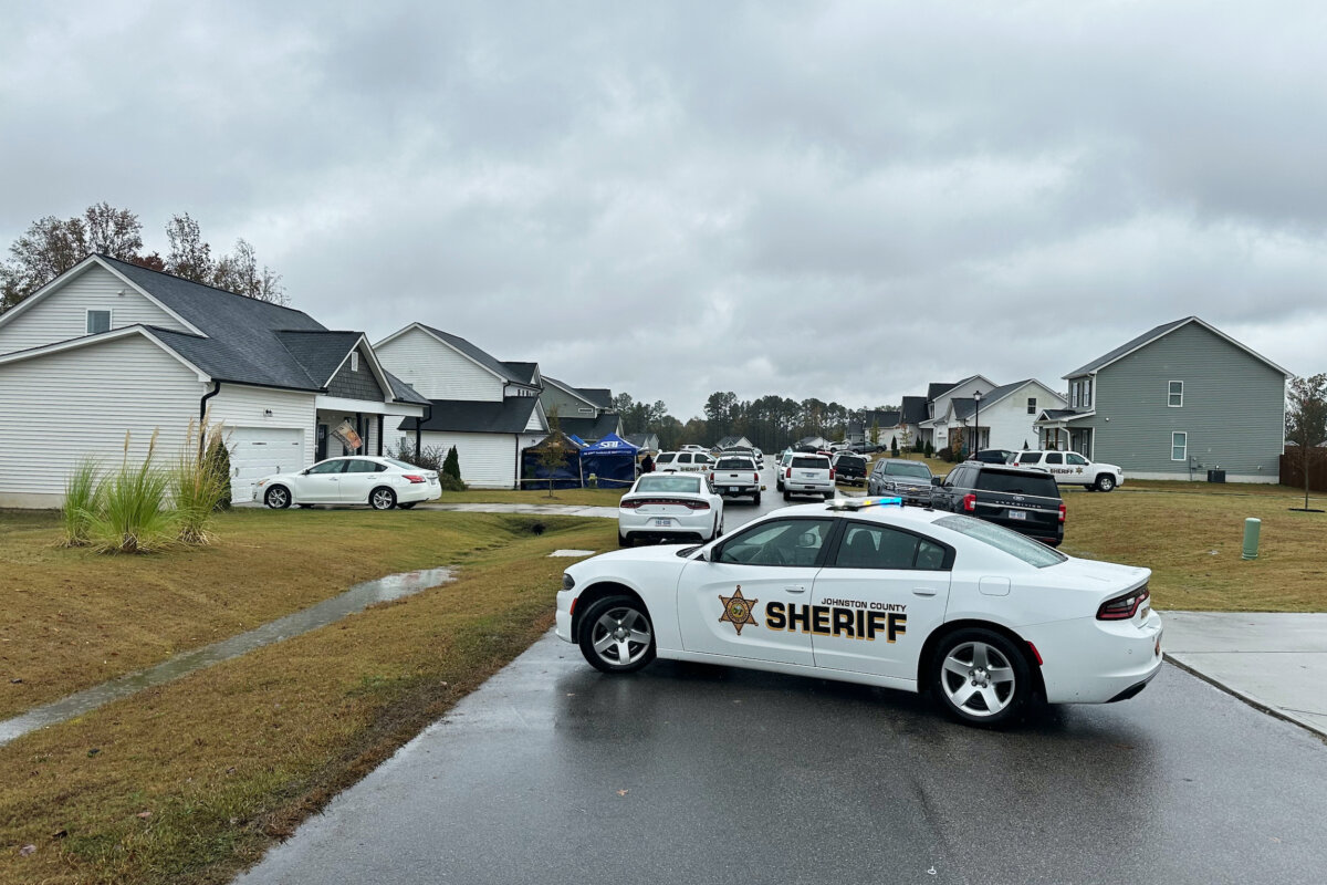 Law enforcement vehicles block the road to Wellington Delano Dickens III's home, where remains were found after Dickens told authorities he had killed four of his children, in Zebulon, N.C., on Oct. 28, 2025. (Allen G. Breed/AP Photo)