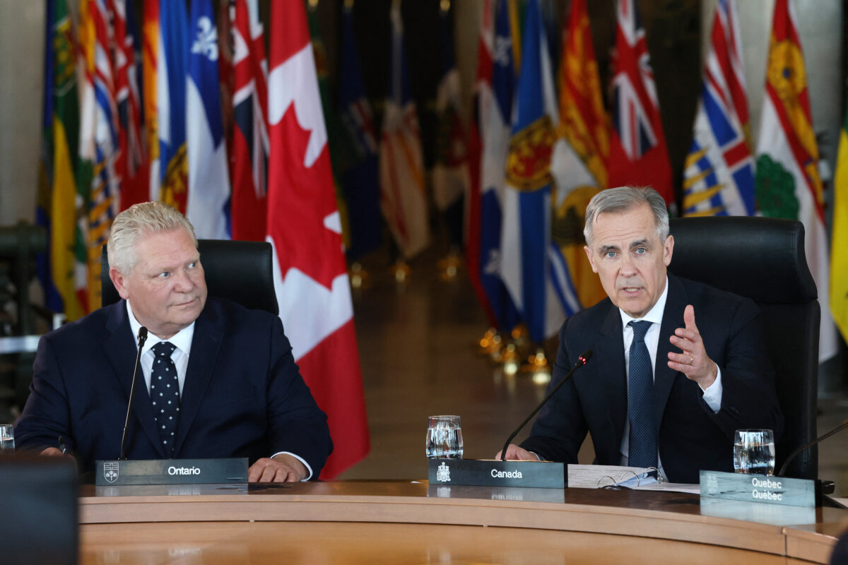 Canadian Prime Minister Mark Carney speaks at the first ministers meeting in Ottawa as Ontario Premier Doug Ford (L) looks on, on March 21, 2025. (Dave Chan/AFP via Getty Images)