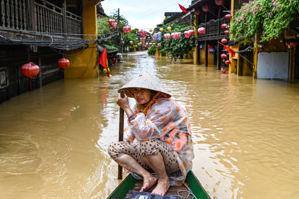 A woman rows a boat on a flooded street following heavy rains in Hoi An, Vietnam, on Oct. 30, 2025. Vietnam's coastal provinces have been lashed by heavy rains since Oct. 26, with a record of up to 1.7 meters (5 feet 7 inches) falling over 24 hours. (Nhac Nguyen/AFP via Getty Images)