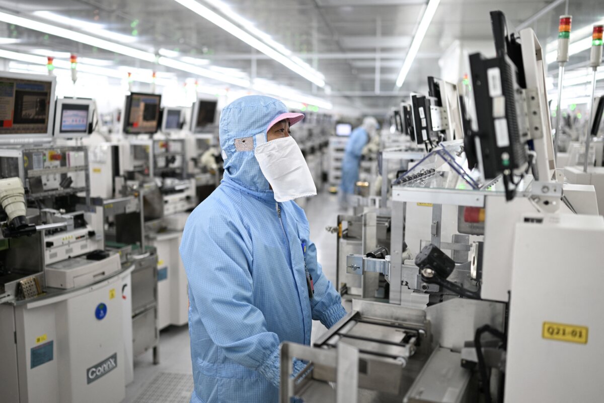 Technicians work on chip processing equipment at a semiconductor manufacturing plant in Suqian, in eastern Jiangsu Province, China, on Oct. 20, 2025. (STR/AFP via Getty Images)
