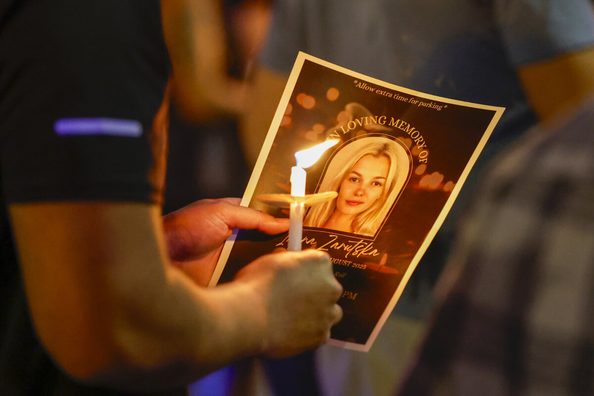 Community members gather for a vigil honoring the life of Iryna Zarutska, who was fatally stabbed on a commuter train in Charlotte, N.C., on Sept. 22, 2025. (AP Photo/Nell Redmond)