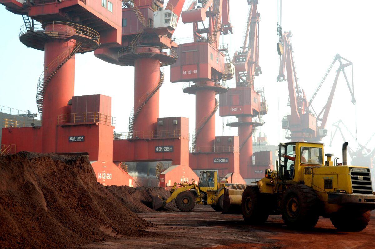 Workers transport soil containing rare earth elements for export at a port in Lianyungang, Jiangsu province, China, on Oct. 31, 2010. (Stringer /Reuters)