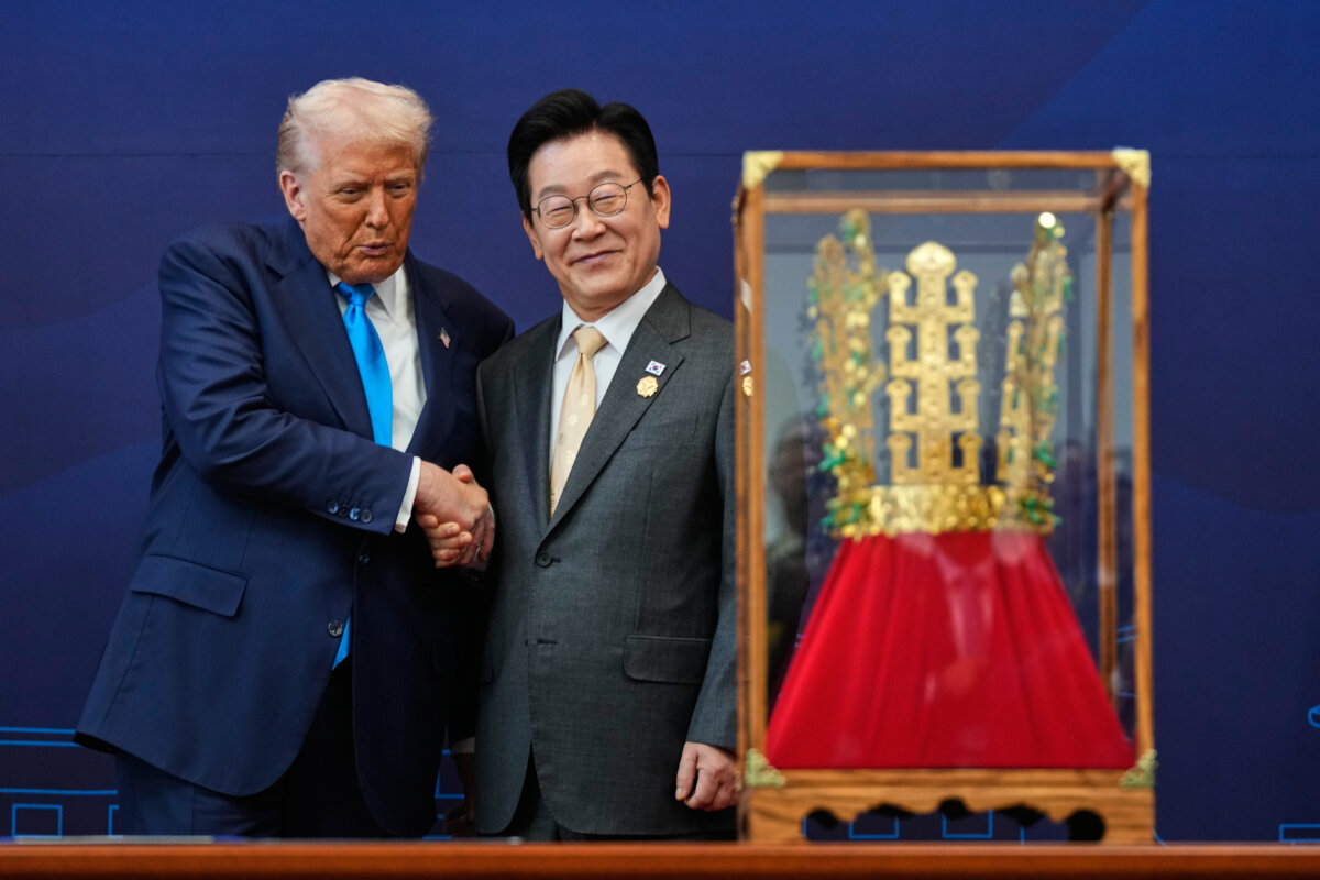 President Donald Trump shakes hands with South Korean President Lee Jae Myung as he receives a gift of a gold crown and an award of the Grand Order of Mugunghwa, not seen, during a high honor ceremony at the Gyeongju National Museum in Gyeongju, South Korea on Oct. 29, 2025. (AP Photo/Mark Schiefelbein)