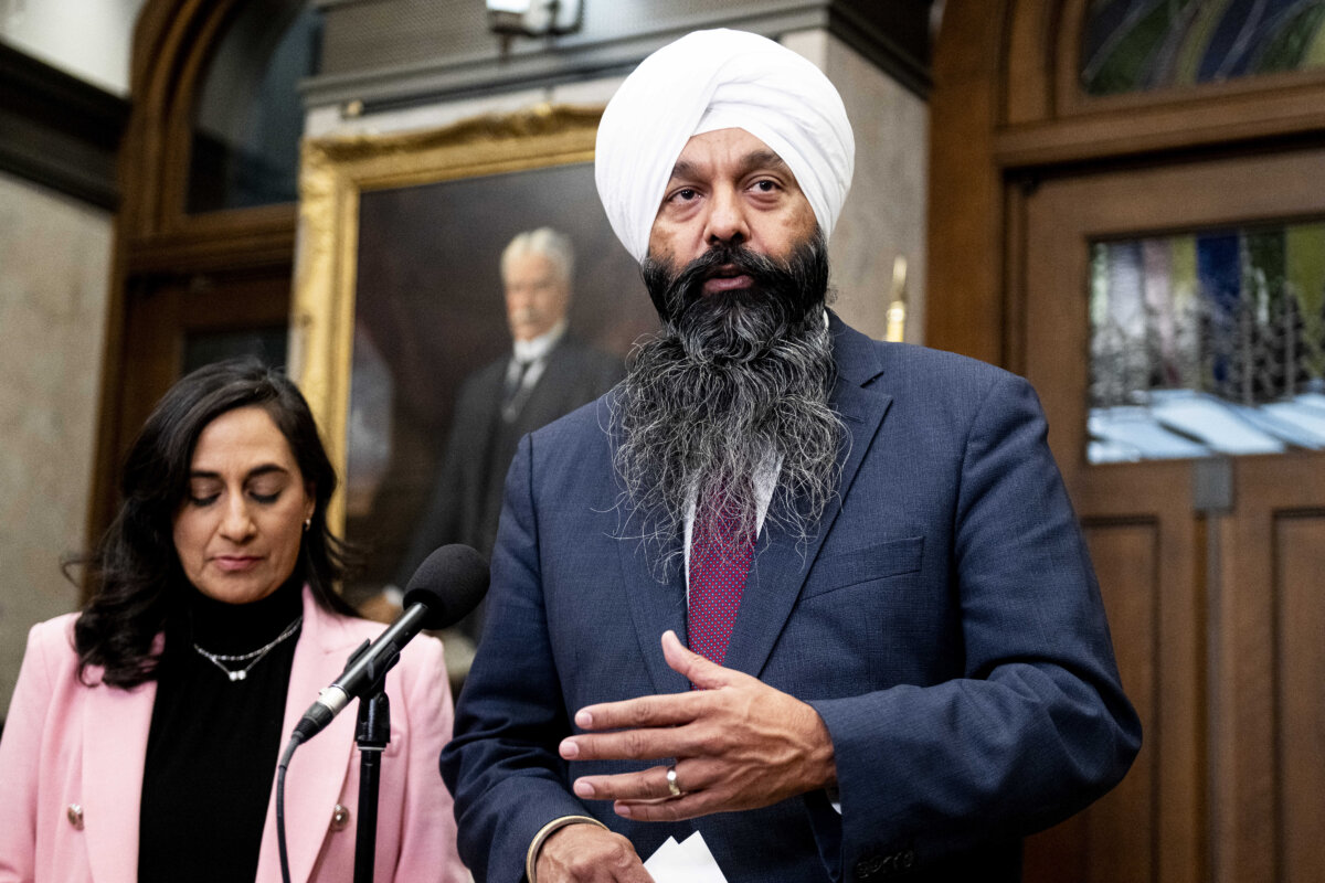 Secretary of State for International Development Randeep Sarai, speaks as Minister of Foreign Affairs Anita Anand looks on during a press conference on Parliament Hill in Ottawa on Oct. 30, 2025. (The Canadian Press/Spencer Colby)