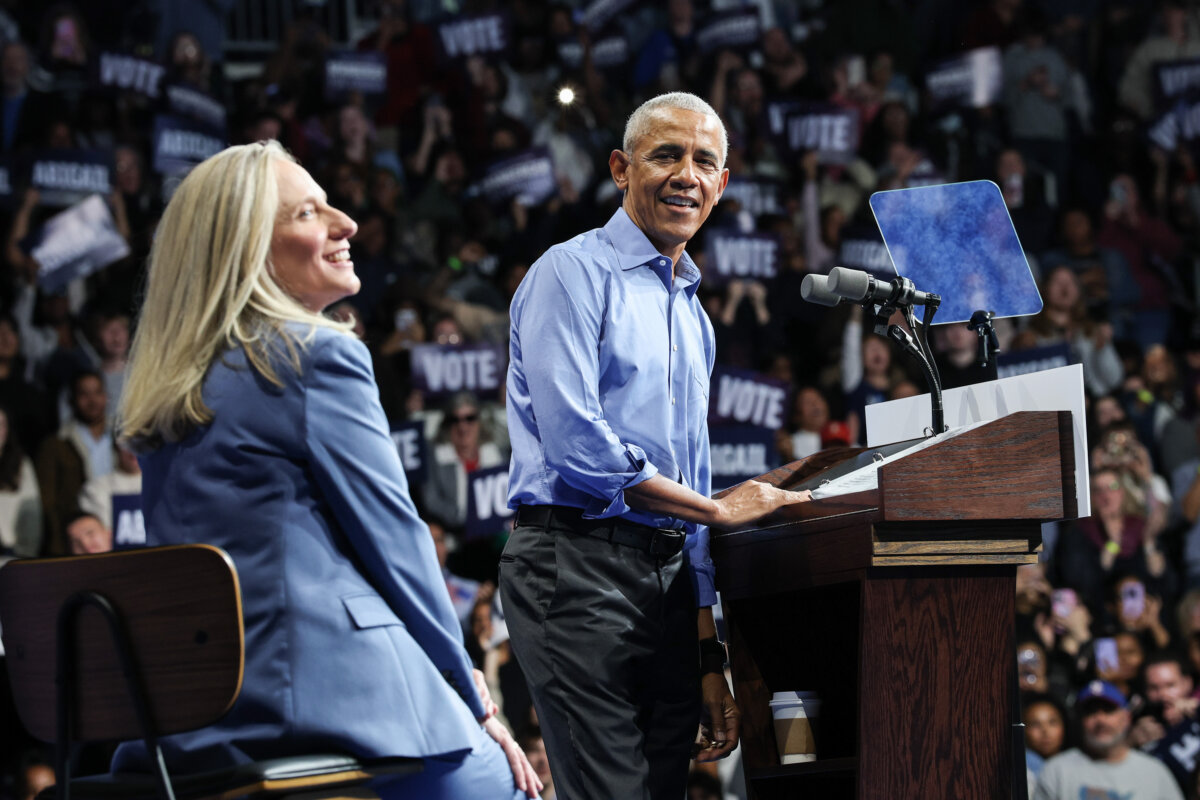 Former U.S. President Barack Obama speaks as Virginia Democratic gubernatorial candidate, former Rep. Abigail Spanberger (L), sits next to him during a campaign rally in the Chartway Arena in Norfolk, Va., on Nov. 1, 2025. (Win McNamee/Getty Images)