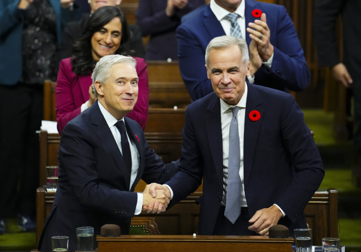 Finance Minister François-Philippe Champagne (L) shakes hands with Prime Minister Mark Carney after delivering his budget speech in the House of Commons, in Ottawa on Nov. 4, 2025. (The Canadian Press/Sean Kilpatrick)