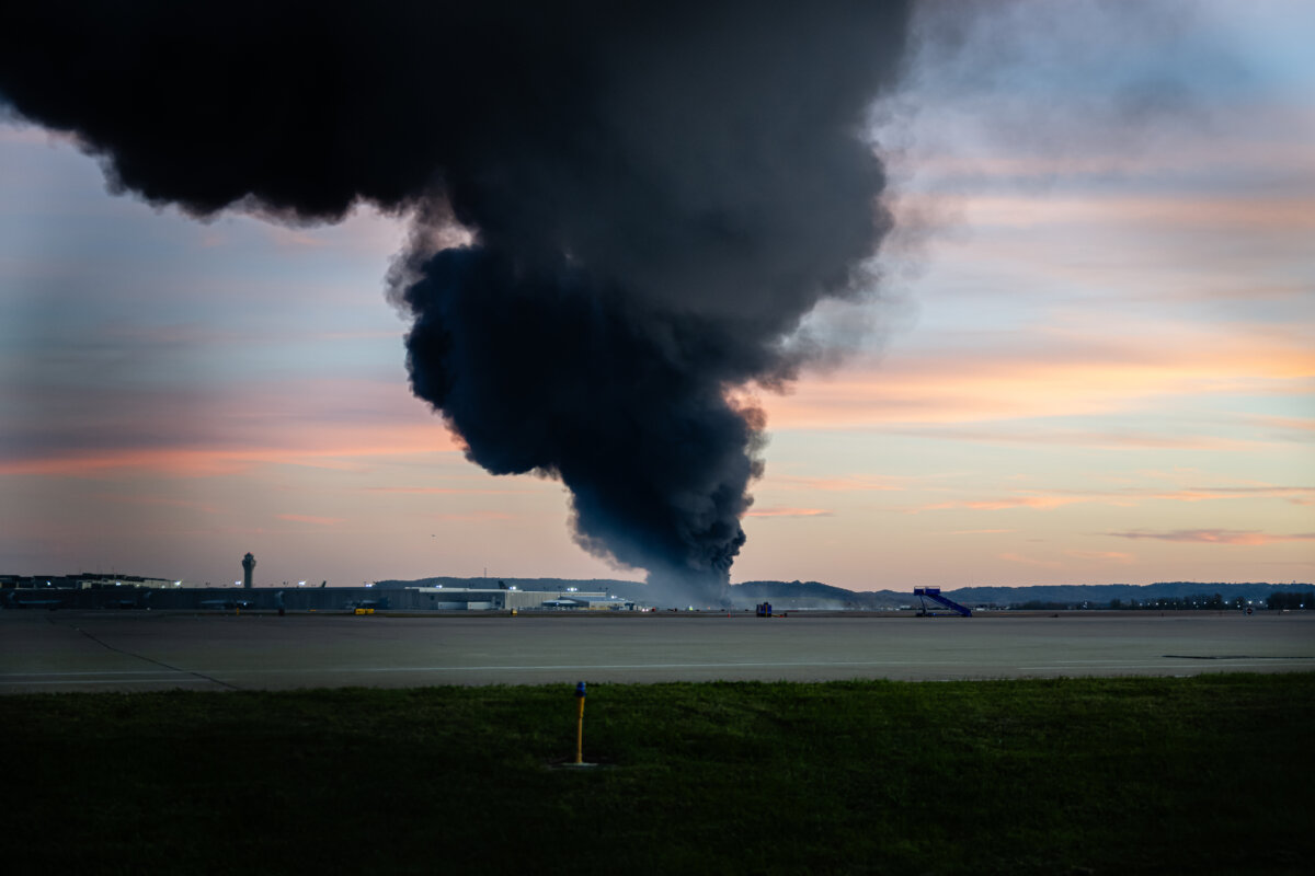 A plume of smoke rises from the site of a UPS cargo plane crash at Louisville Muhammad Ali International Airport in Louisville, Ky., on Nov. 4, 2025. (Jon Cherry/AP Photo)
