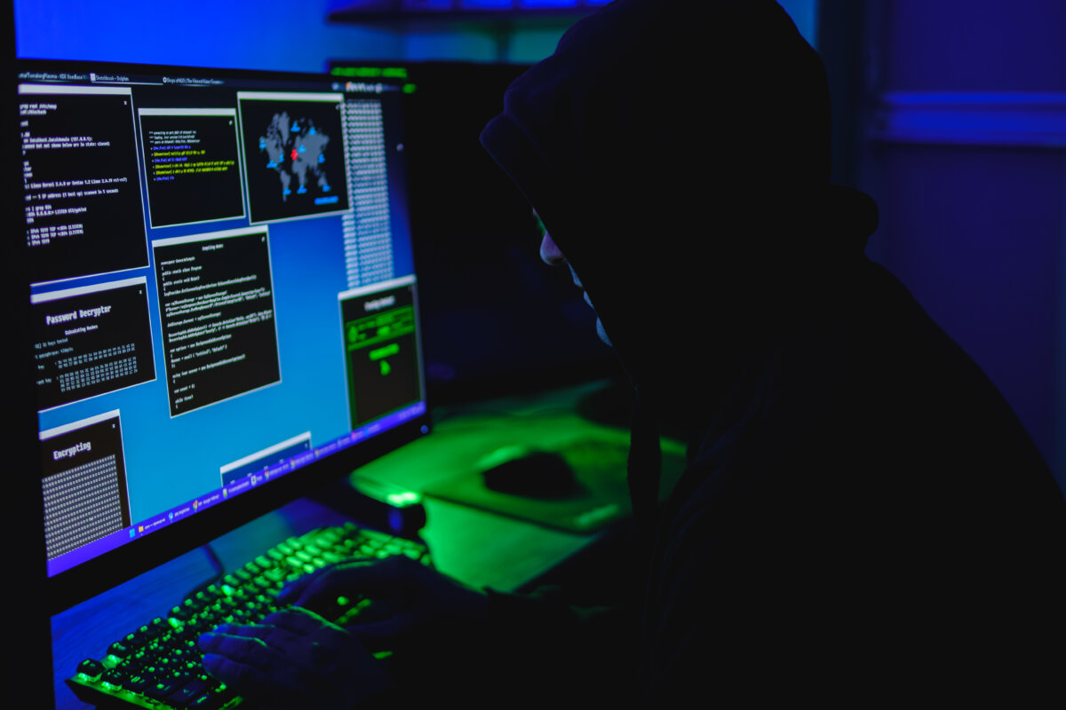 In this photo illustration, a hacker types on a computer keyboard on May 13, 2025. (Oleksii Pydsosonnii/The Epoch Times)