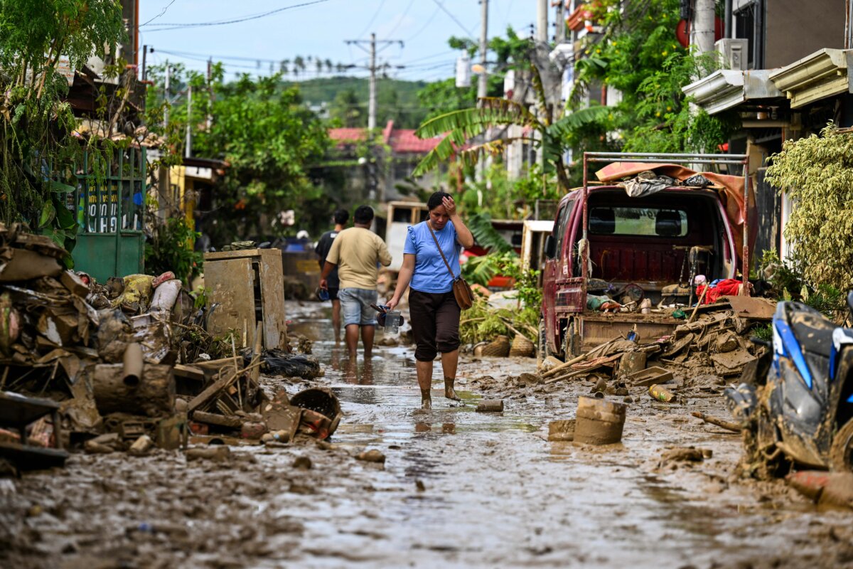 A woman walks along a mud covered street in the aftermath of Typhoon Kalmaegi in Liloan, in the province of Cebu, Philippines, on Nov. 6, 2025. The death toll from Typhoon Kalmaegi in the central Philippines climbed past 100, as the devastating impact on Cebu province became clearer after the worst flooding in recent memory. (Jam Sta Rosa/AFP via Getty Images)