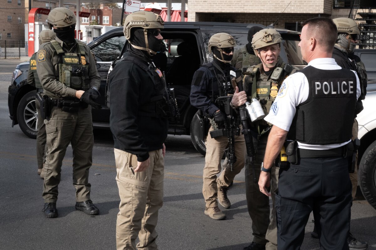 Border Patrol chief Greg Bovino speaks with a Chicago Police officer while searching for illegal immigrants in a southwest side neighborhood in Chicago on Nov. 6, 2025. (Scott Olson/Getty Images)