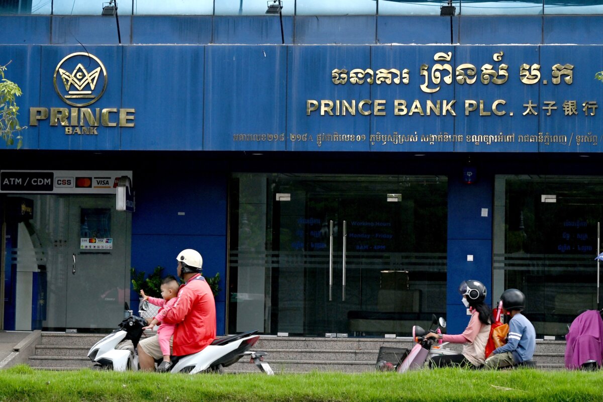 Motorists ride past a branch of the Prince Bank in Phnom Penh, Cambodia, on Oct. 15, 2025. (Tang Chhin Sothy/AFP)