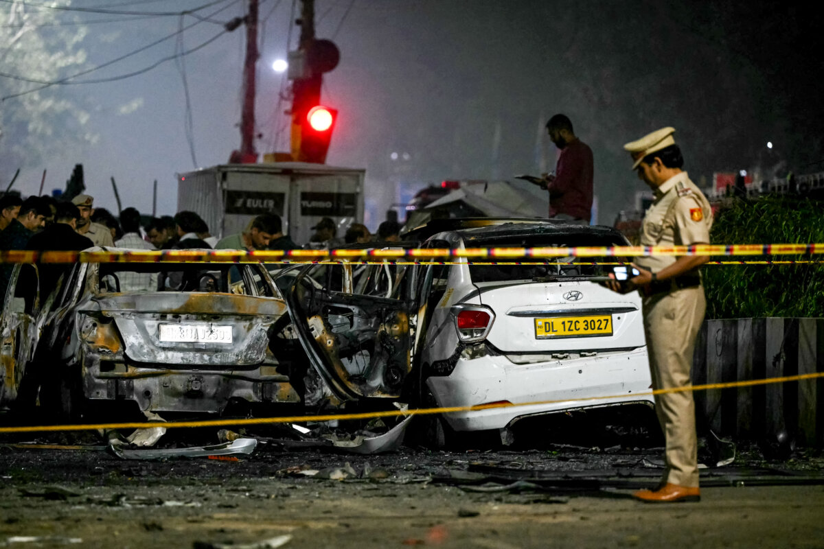 Police personnel inspect charred vehicles at the blast site after an explosion near the Red Fort in the old quarters of Delhi, India, on Nov. 10, 2025. Indian fire officers reported injuries after fire engulfed several vehicles, but the cause of the blaze was not confirmed. (Sajjad Hussain/AFP via Getty Images)