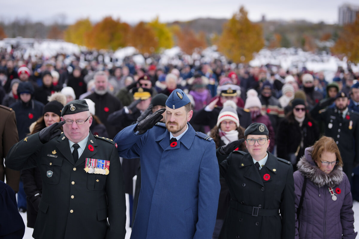 Canadian Forces members salute during the playing of the Last Post at a Remembrance Day ceremony at the national military Cemetery at Beachwood in Ottawa on Nov. 11, 2025. (The Canadian Press/Justin Tang)