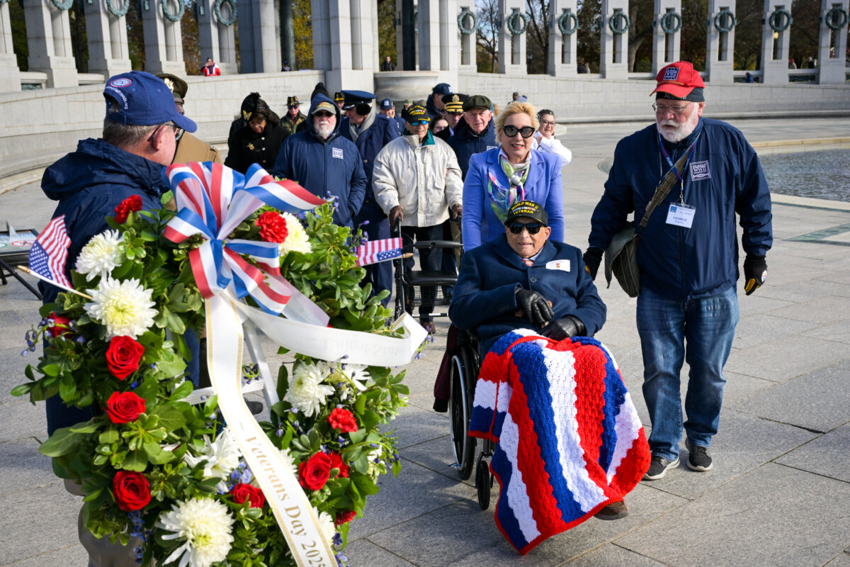 Witold Brick (in wheelchair), a 102-year-old World War II veteran, participates in a wreath-laying ceremony at the World War II Memorial in observance of Veterans Day in Washington on Nov. 11, 2025. (Oliver Contreras/AFP via Getty Images)