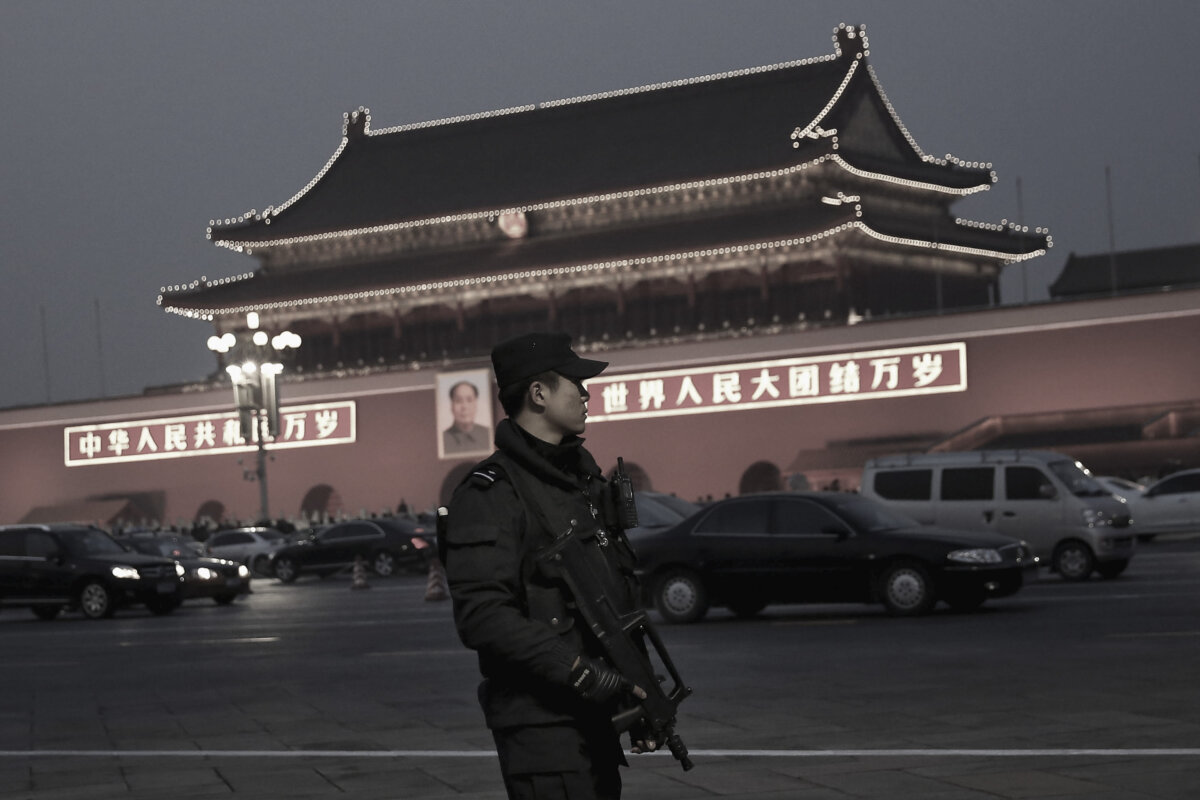 A police officer patrols with his gun on Tiananmen Square in Beijing in a file photo. (Feng Li/Getty Images)