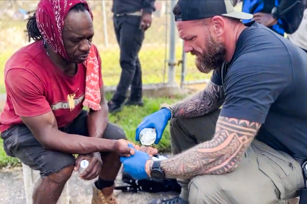 Aerial Recovery Co-founder and COO Jeremy Locke (R) cleans a wound while providing disaster recovery efforts in Jamaica on Nov. 4, 2025. (Courtesy of Aerial Recovery)