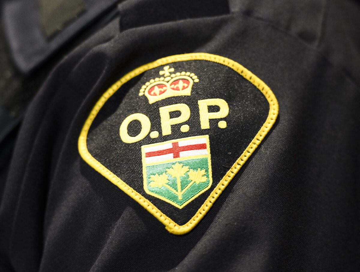 An Ontario Provincial Police logo is shown during a press conference, in Barrie, Ont., on April 3, 2019. (The Canadian Press/Nathan Denette)