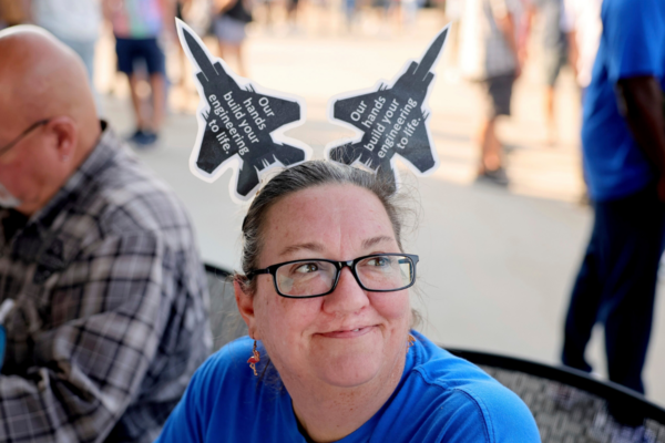 Christy Williams greets people at the voting check-in table where International Association of Machinists and Aerospace Workers union members picked up their ballot to vote on a negotiated tentative labor agreement that would end their strike against Boeing Defense St. Louis regional operations. in Maryland Heights, Mo., on Sept. 12, 2025. (David Carson/St. Louis Post-Dispatch via AP)