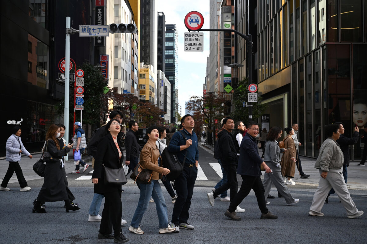 A Chinese tour group walks at the Ginza shopping district of Tokyo on Nov. 16, 2025. (Greg Baker/ AFP via Getty Images)